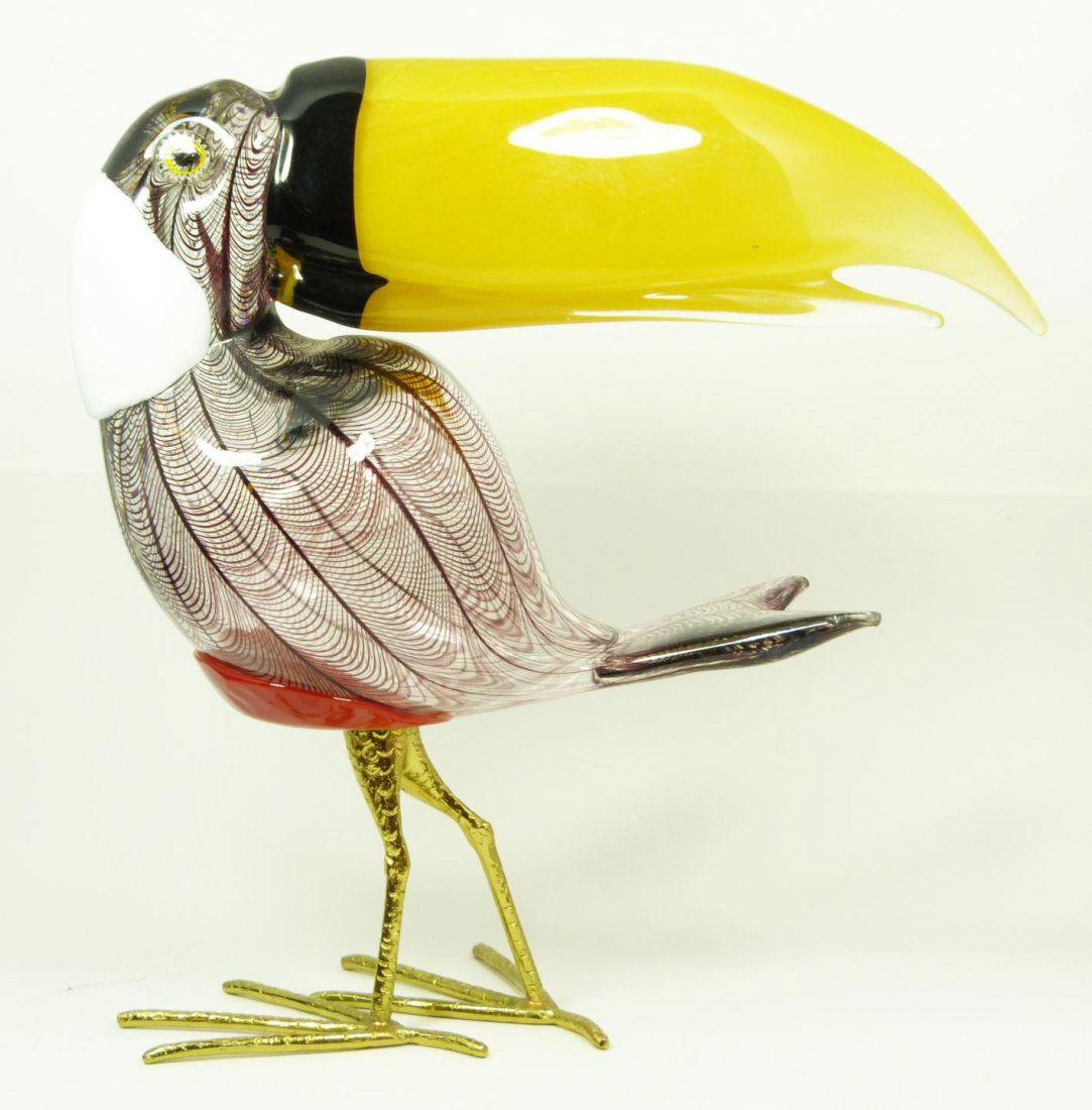 ART GLASS TOUCAN SCULPTURE SIGNED: Art glass sculpture depicting a toucan with gilded metal tarsus. Has overlay web design throughout with red glass belly and white nape. 14 1/4" height x 14" length (36.1cm x 35.5cm). Total weight of 5