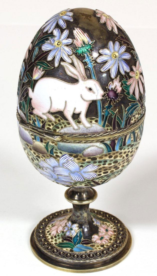 RUSSIAN SILVER ENAMELED EGG OVCHINNIKOV: Russian silver enameled hinged egg box depicting rabbits with flowers. Gold wash throughout. Holds Cyrillic Pavel Akimov Ovchinnikov "NO" workmaster marks. Holds 84 silver purity mark with town mark a
