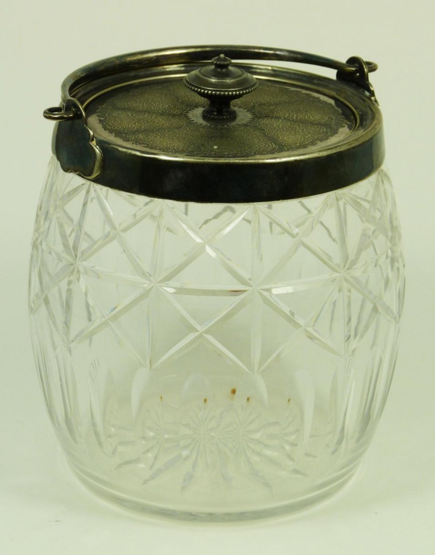 BACCARAT FRENCH CUT GLASS SILVERPLATE CANISTER: Old Baccarat French cut glass and silver plate canister having a barrel shape. Has intricate chased design to cover depicting scrolled vines and flowers. Measures 6 1/8" height (15.5cm). Total weight 