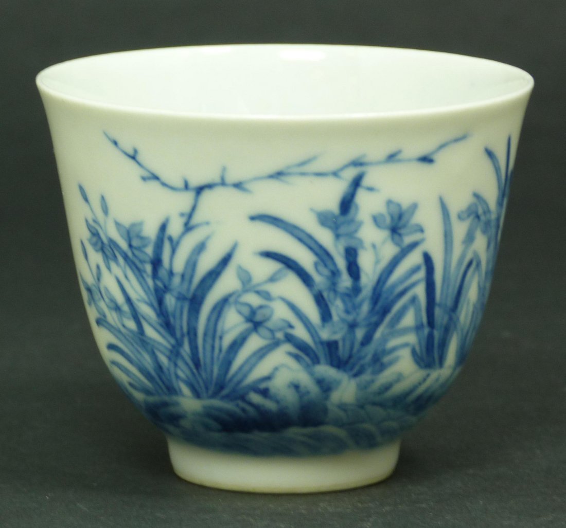 17th/18th C EGG SHELL PORCELAIN KANGXI WINE CUP: Antique Chinese porcelain egg shell porcelain Kangxi wine cup finely potted with gently rounded sides delicately painted in various shades of cobalt-blue to depict a floral scene. The reverse side wit