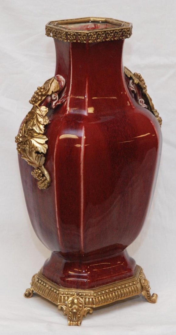 18th C CHINESE OXBLOOD VASE w BRONZE MOUNTINGS: Antique Chinese Qing Dynasty period sang de boeuf glaze vase having figural Chih Lung Dragon handles and hu form. Many years after this vase was produced it was mounted with a bronze footed base and c