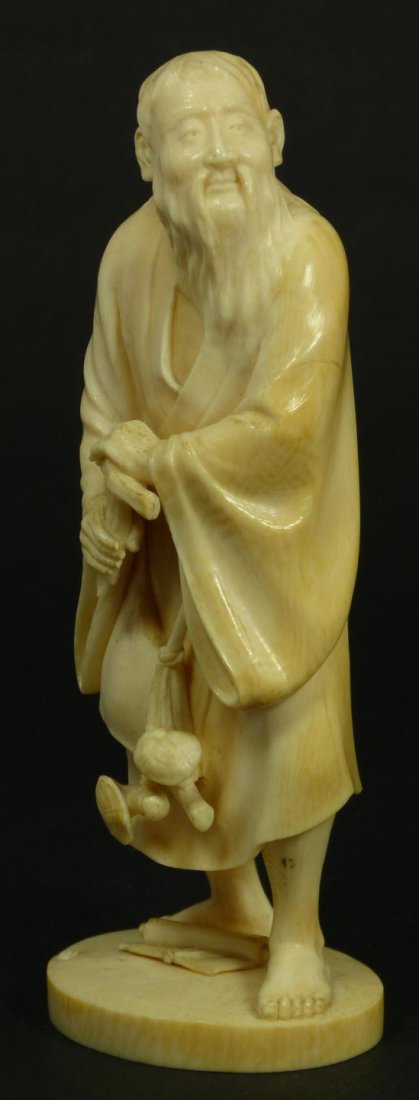 CHINESE CARVED IVORY FIGURE OF BEARDED ELDER: Old Chinese hand carved ivory figure depicting a bearded elder with cane. A satchel can be seen hanging from his body with mushrooms hanging from it. Holds etched Mei a' Dao signature to bottom. 19th/