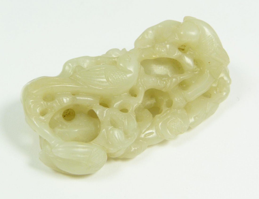 CHINESE CARVED WHITE JADE BIRD GROUP TOGGLE: Antique Qing Dynasty Chinese fully relief carved jade bird group toggle depicting birds with root form designs. Translucent white jade specimen with even tone throughout. 18th/19th century. Measures 2