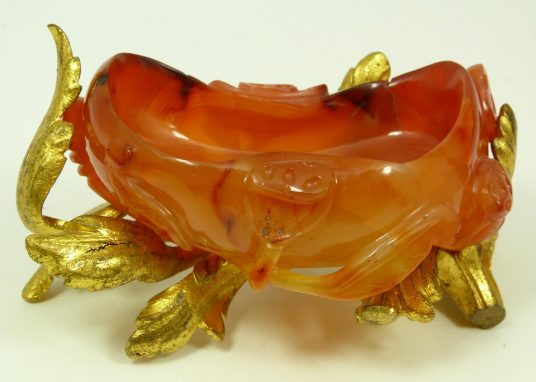 CHINESE CARVED CARNELIAN WATER COUPE BRONZE STAND: Antique Chinese hand carved carnelian stone scholar's desk water coupe having gilded bronze leaf form fitted mount. Has hollowed gourd shape with roots. 19th century. Measures 3 3/4" length x 2 1/2" w