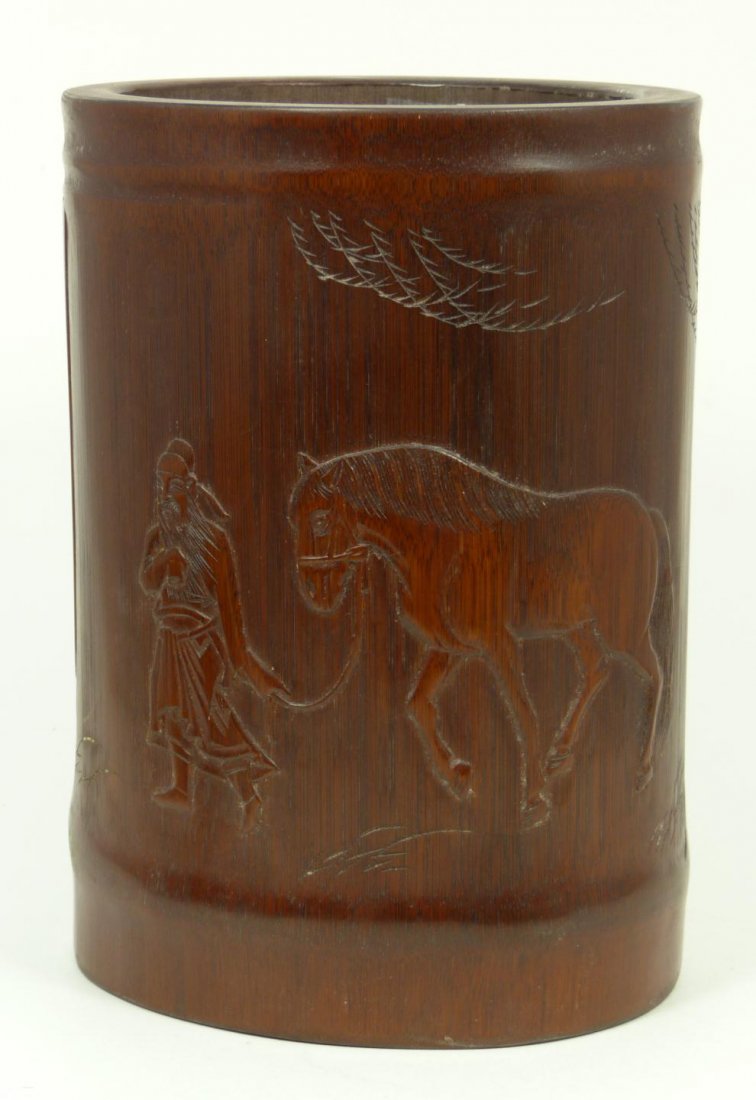 19th CENTURY CHINESE CARVED BAMBOO BRUSH POT: Antique Chinese hand carved bamboo brush pot having a relief scene of scholar with horse and etched calligraphy to verso. Well hollowed interior. Late Qing dynasty. Measures 7 1/2" height x 5 5/8" wid