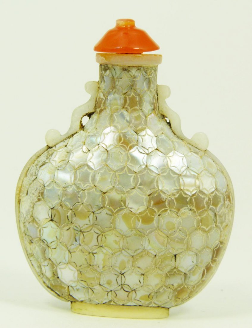 CHINESE FISH SCALED MOTHER OF PEARL SNUFF BOTTLE: Chinese mother of pearl snuff bottle having a fish scale design throughout. Has ivory foot and spoon with agate cover. 19th/20th century. Measures 2 1/2" height (6.3cm). Total weight of 16 grams.