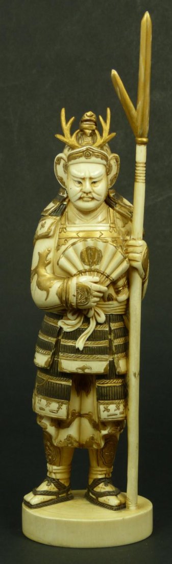 19th C JAPANESE CARVED IVORY SAMURAI FIGURE SIGNED: Antique Japanese hand carved and polychromed ivory samurai figure. Fully relief carved throughout to depict him standing with spear to left hand. Has fan to right hand. Bronze and gold tones throughou