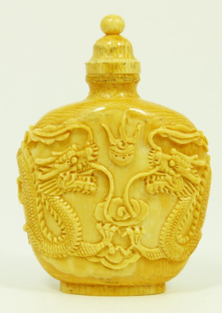 CHINESE CARVED IVORY DRAGONS SNUFF BOTTLE: Chinese high relief carved ivory dragons snuff bottle depicting two dragons and jewel. 19th/20th century. Measures 2 3/4" height x 2" width (6.9cm x 5.1cm). Total weight of 47 grams.