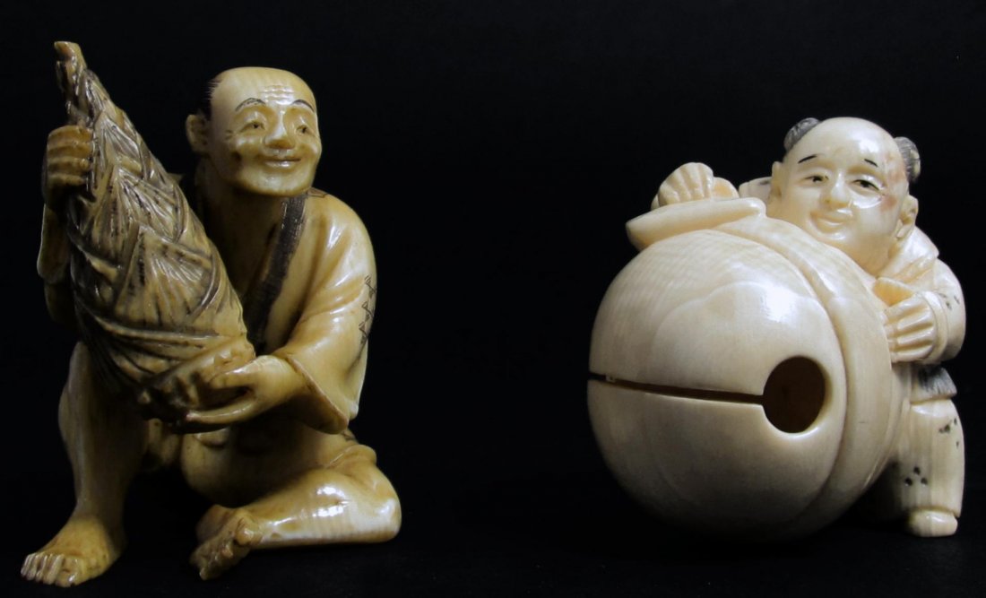 2 JAPANESE CARVED IVORY NETSUKE OF w OBJECTS: 2 Japanese hand carved ivory netsuke figures depicting men holding objects. One is depicted holding a bell and the other a pine cone. Each figure is signed. Each approx. 1 5/8" height (4.1cm). Total w