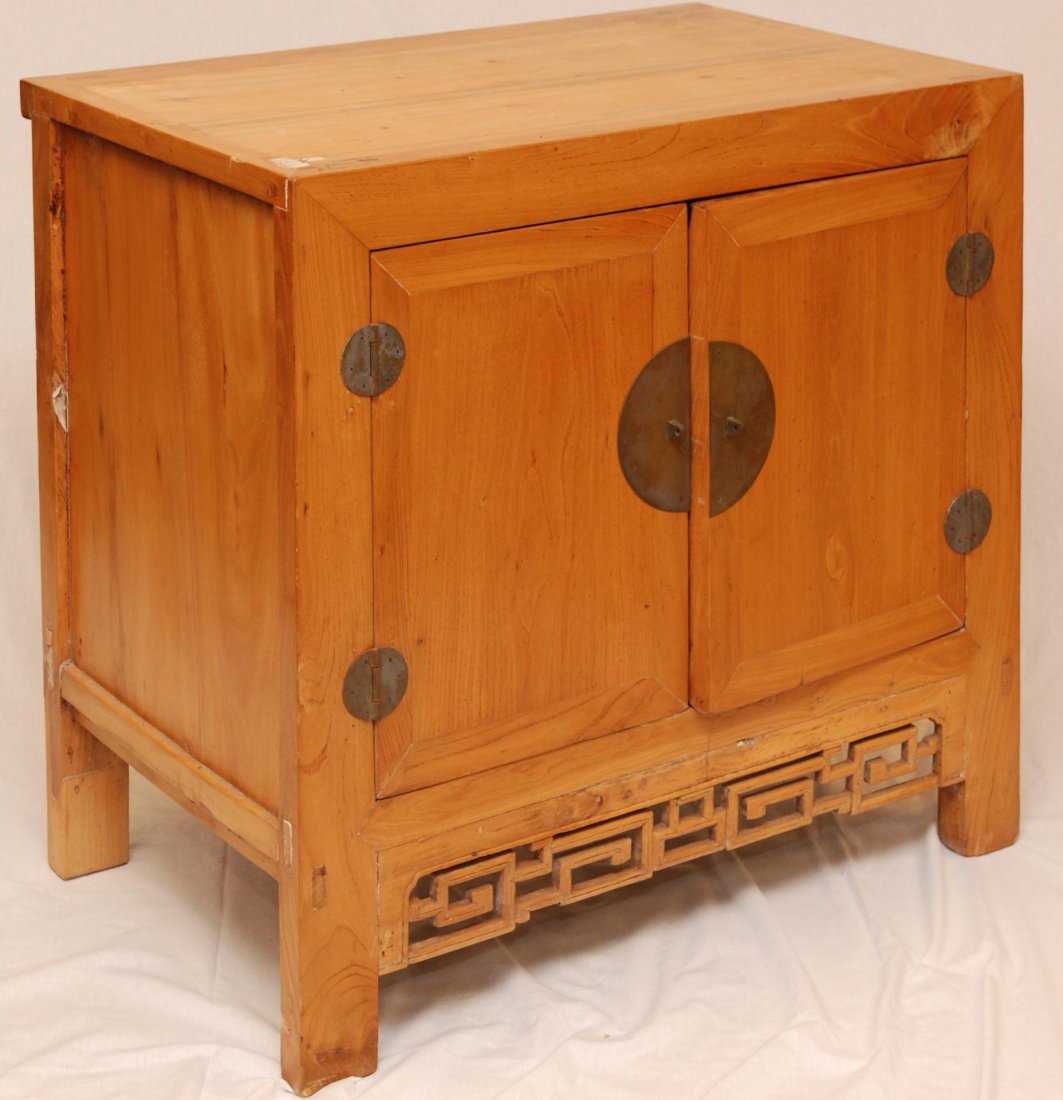 19th C CHINESE YELLOW ELM WOODEN CABINET: Chinese antique hand crafted yellow elm wooden cabinet having bronze hinges and disc cladding with handles to center. Double door design with one shelf to interior. 19th/20th century. Measures 35" x 3