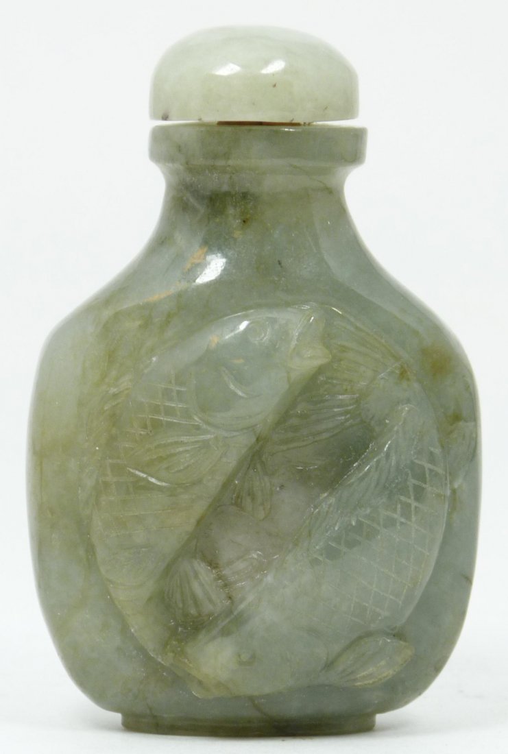 ANTIQUE CHINESE JADEITE DOUBLE FISH SNUFF BOTTLE: Antique Chinese relief carved jadeite snuff bottle having a two fish design to one side with rounded shape. Made 19th century. Measures 3" height (7.6cm). Total weight of 128 grams.