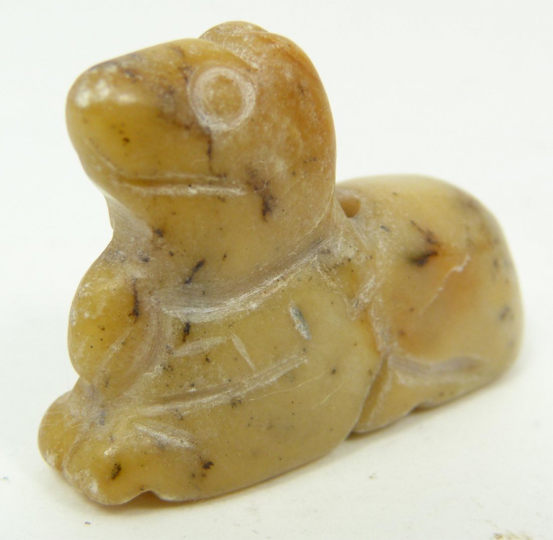 HAN DYNASTY CHINESE CARVED YELLOW HARDSTONE DOG: Han dynasty Chinese hand carved yellow hardstone recumbent dog figural bead. Measures 1" height x 1 1/2" length (2.5cm x 3.8cm). Total weight of approx. 13 grams.