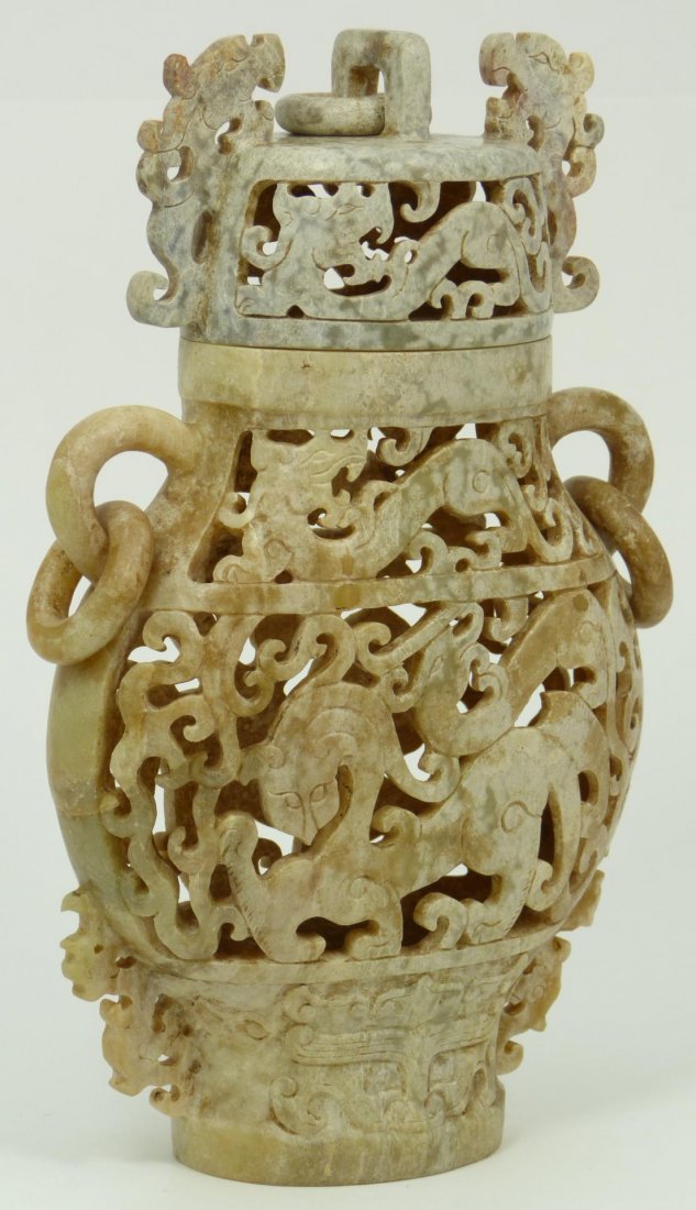 ARCHAIC STYLE CHINESE CARVED SOAPSTONE VASE: Archaic style Chinese carved soapstone vase having reticulated body and cover depicting mythical beasts. Has fully relief carved rings. Measures 8 1/2" height x 6" width (21.6cm x 15.4cm). Total weigh
