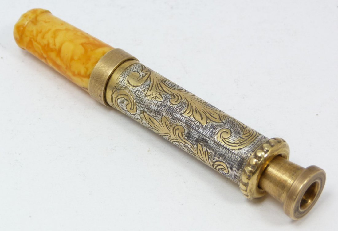 OLD RUSSIAN CHASED SILVER CIGARATTE HOLDER: Russian silver hand chased cigarette holder with Bakelite tip and adapter. Has scrolled leaf design with gold wash. Holds 84 silver purity mark. Also holds work master mark. Measures 4 1/8" (10.5cm) l