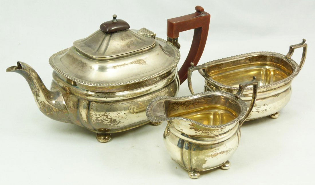 3pc ENGLISH STERLING SILVER TEA SET: Old 3 piece Northern Goldsmiths Company English sterling silver tea set including sugar, creamer and teapot. Holds Anchor town mark of Birmingham. Holds Lion passant guardant certifying the silver qua
