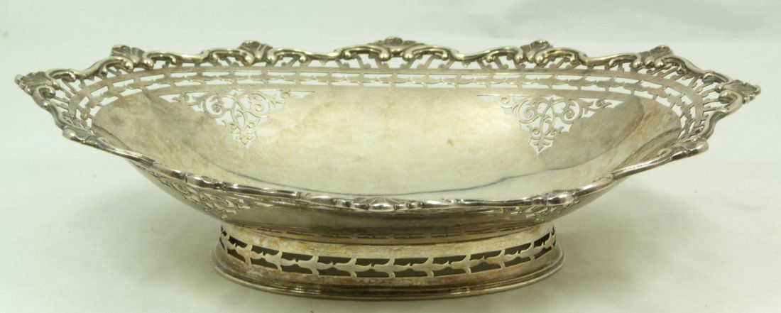 ENGLISH STERLING SILVER RETICULATED FOOTED DISH: Antique William Hutton & Sons Ltd. English sterling silver reticulated bowl having an intricate scrolled design. Scrolled shell design to border. Holds Lion passant guardant certifying the silver qual