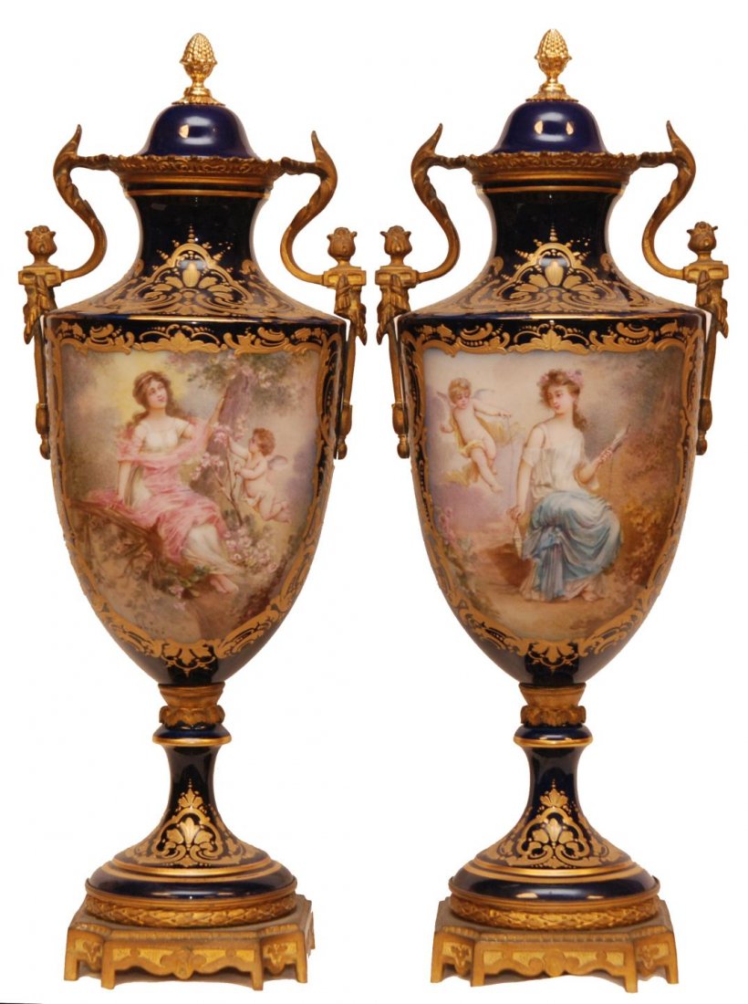Pr ANTIQUE SEVRES FRENCH PORCELAIN COBALT URNS: Pair of antique Sevres French porcelain urns with Dore bronze handle and foot mountings. Hand painted landscape and scenes with women and cherubs. Each scene signed "Lhere". Hand painted gilt floral s