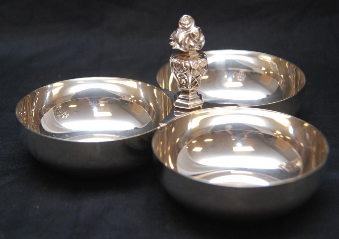 CHRISTOFLE FRANCE SILVERPLATE DIVIDED CANDY DISH: A Christofle French silver plate divided candy dish having three round bowls and figural flaming torch handle. Holds impressed Christofle marks to bottom. Second half of 20th century. Measures 4 3/8" 
