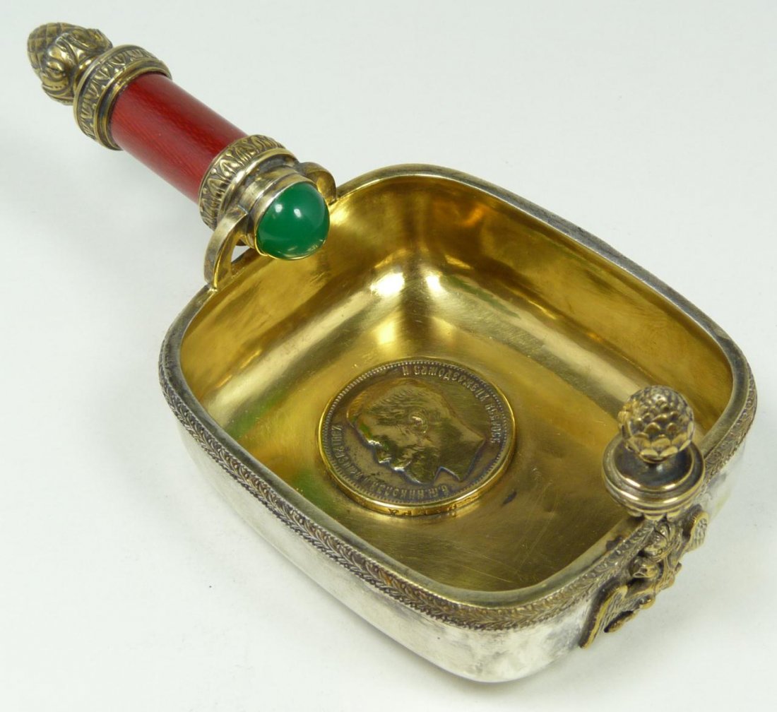 RUSSIAN SILVER ENAMELED KOVSH w COIN: Russian silver Kovsh having red guilloche enamel hand holding emerald stone. Has Ruble coin set to interior. Handle has a figural acorn design. Front has double headed eagle crest. Gold wash interior.
