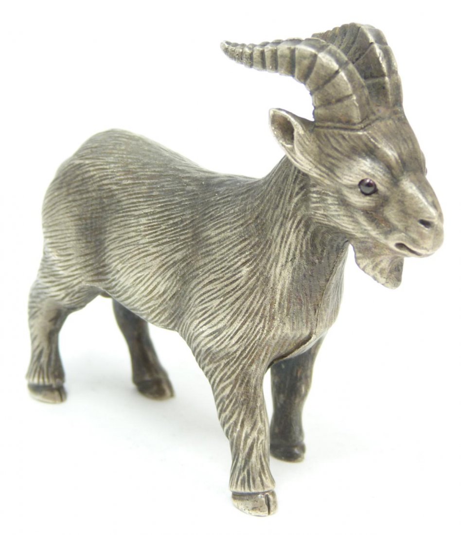 RUSSIAN SILVER GOAT FIGURINE: Russian silver standing goat figure. Has cabochon cut ruby jewels set to eyes. Has town marks and 84 silver purity marks to bottom. Has cabochon cut ruby jewels set to eyes. Also holds Julius Rappapor