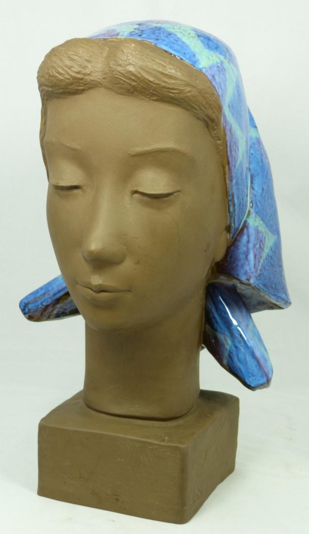 ALUMINIA EARTHENWARE BUST JOHANNES HEDEGAARD: Aluminia Faience Danish earthenware bust of a young girl with head dress. Matte texture throughout with turquoise and blue tone glazed scarf to hair. Holds Aluminia A with waves marks to bottom (Alumi
