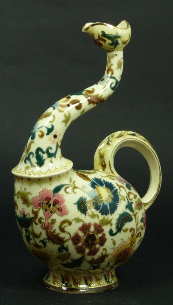 ZSOLNAY HUNGARIAN POTTERY OLIVE OIL VESSEL: Antique Zsolnay Hungarian pottery olive oil vessel having a hand painted floral and gilt design throughout. 19th century. Measures 10" height (25.4cm). Total weight of 431 grams.