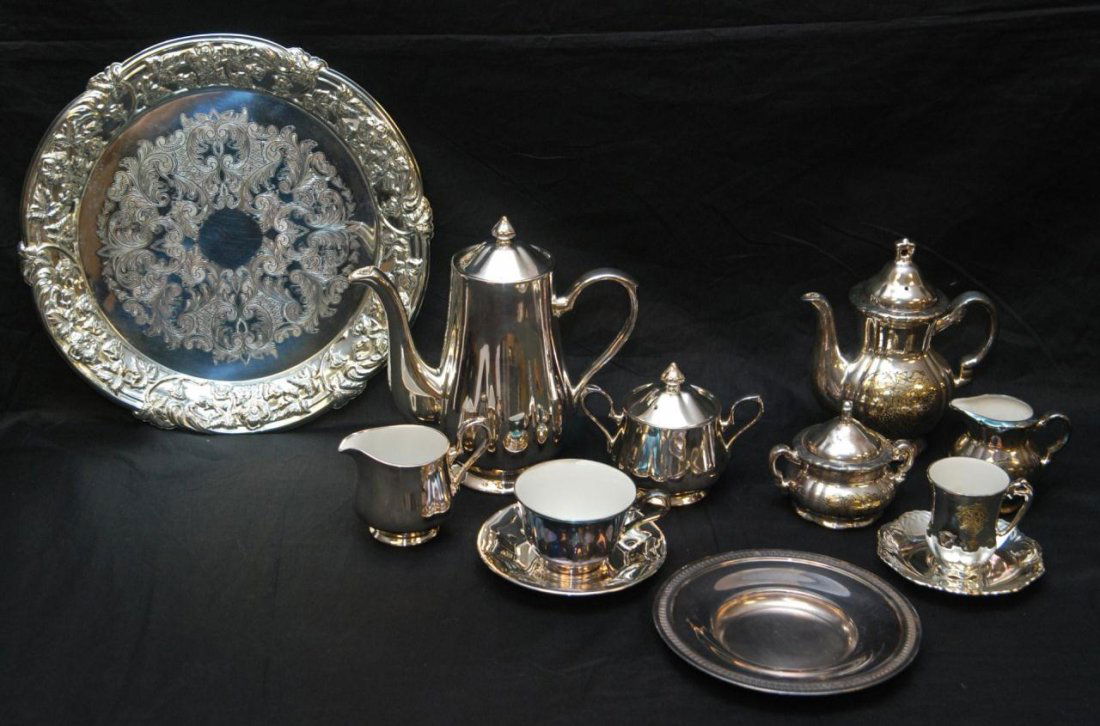 88 PIECE SILVER CLAD PORCELAIN COFFEE & TEA SET: An 88 piece Japanese silver clad porcelain coffee and tea service. Lot includes coffee pot 9 1/2", covered sugar 4 1/2", creamer 3 3/4", 12 cups 2 1/2" and 12 saucers 5 7/8". Tea set has etched floral