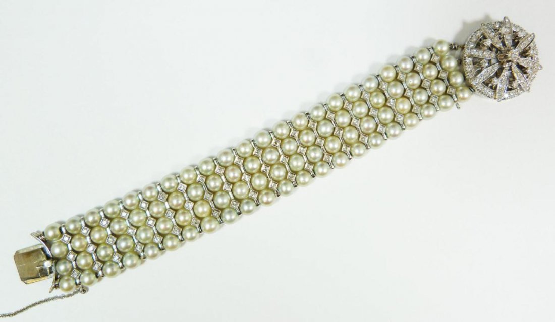 14K WHITE GOLD AND PEARL DIAMOND BRACELET: A ladies 14k white gold bracelet having a four strand design with each row of pearls divided by a bar with diamond designs having three round cut white diamonds set. Total of 63 diamonds approx. 1.26c