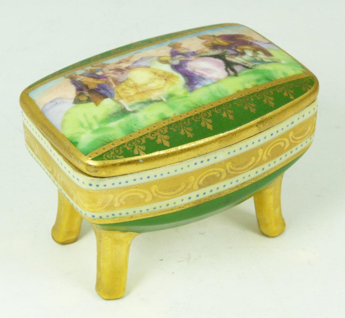 MORITZ ZDEKAUER AUSTRIAN PORCELAIN LIDDED BOX: An antique Moritz Zdekauer Austrian hand painted porcelain footed covered box depicting courting couples. Marked to bottom. 19th century. Measures 2 1/2" height x 3 1/2" width x 2 5/8" depth (6.3cm x