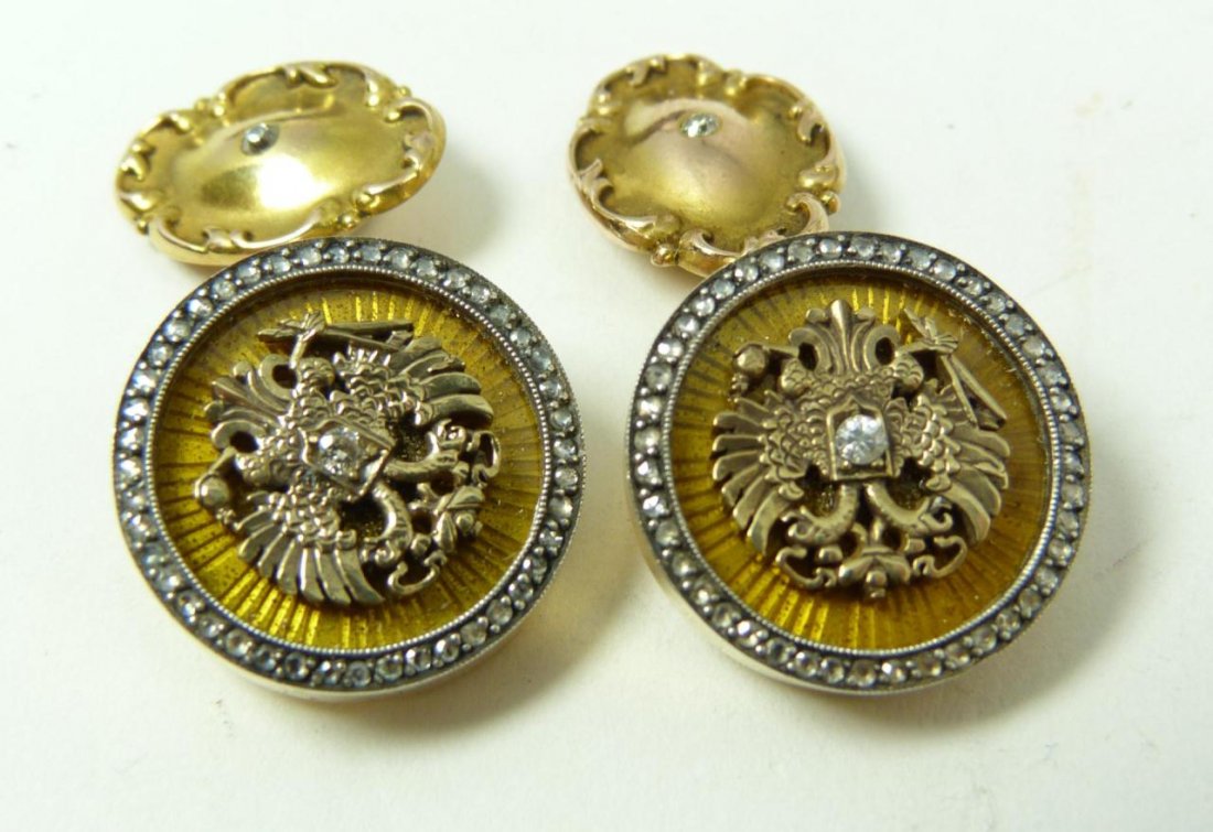 RUSSIAN 14K YELLOW GOLD JEWELED EAGLE CUFFLINKS: A striking pair of Russian 14k yellow gold cufflinks having jeweled double headed eagle with center round cut white diamond. Each cufflink having a yellow guilloche enamel design under double headed e
