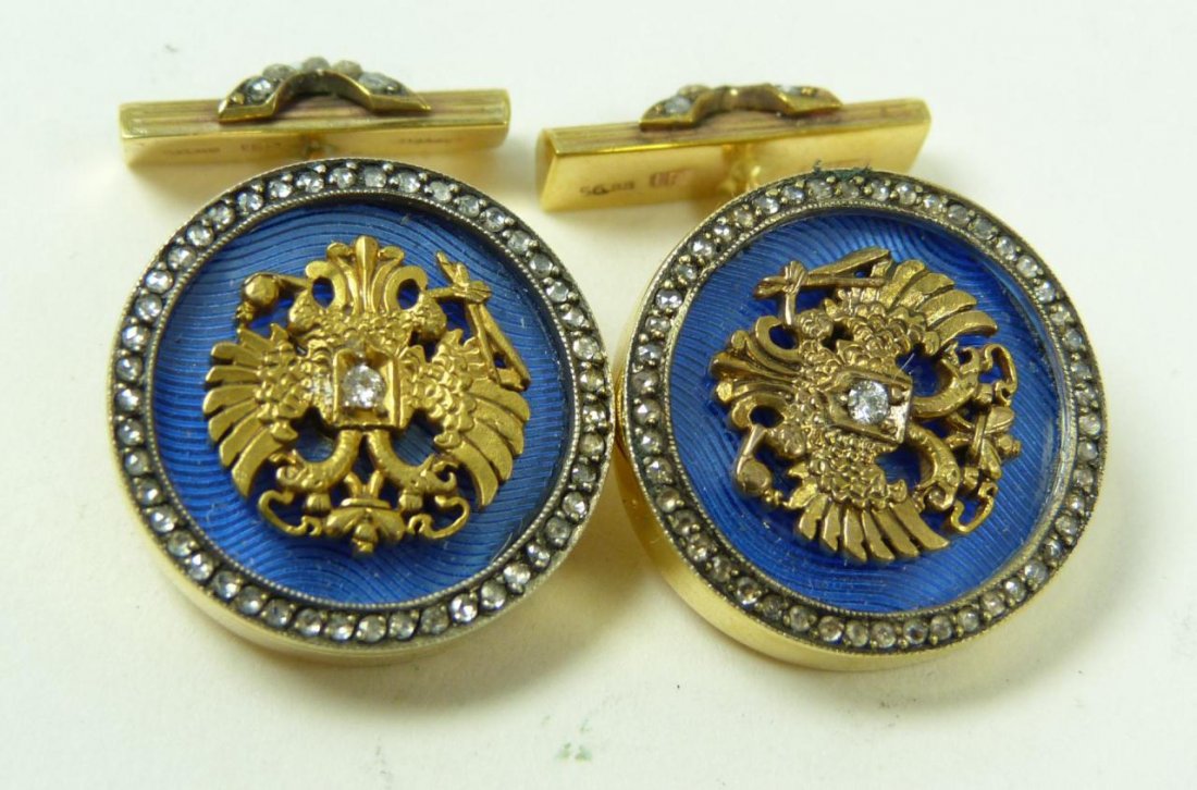 RUSSIAN 14K YELLOW GOLD JEWELED EAGLE CUFFLINKS: A striking pair of Russian 14k yellow gold cufflinks having jeweled double headed eagle with center round cut white diamond. Each cufflink having a blue guilloche enamel design under eagle. Side mount