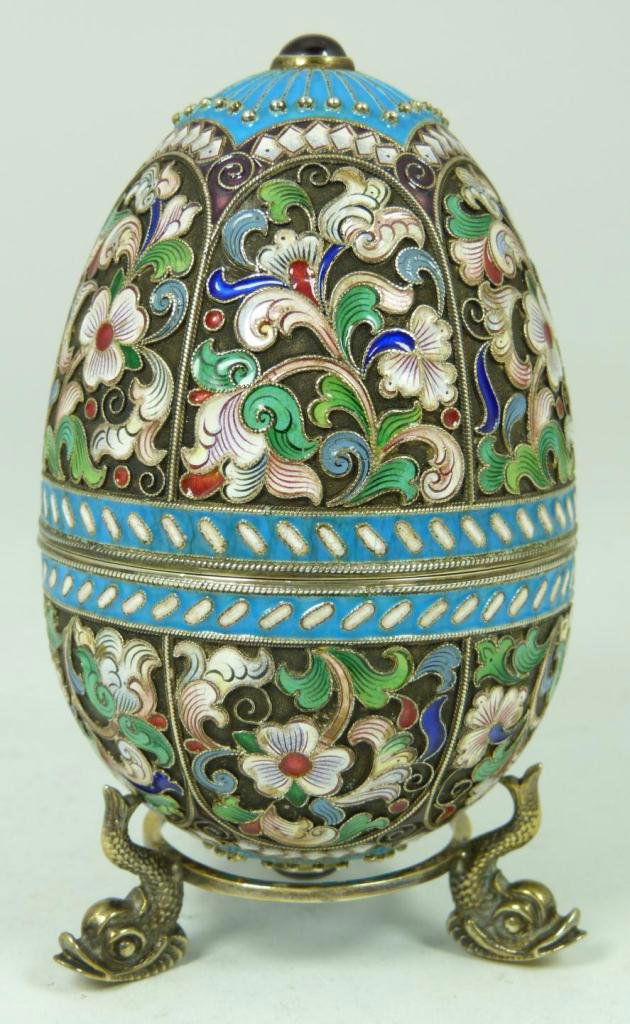 RUSSIAN SILVER ENAMELED FLORAL EGG: Finely crafted Russian silver egg with multicolor enameled design throughout. Has Cabochon garnet to top and bottom. Holds 88 silver purity mark and Feodor Ruckert Cyrillic work master marks. Marked t