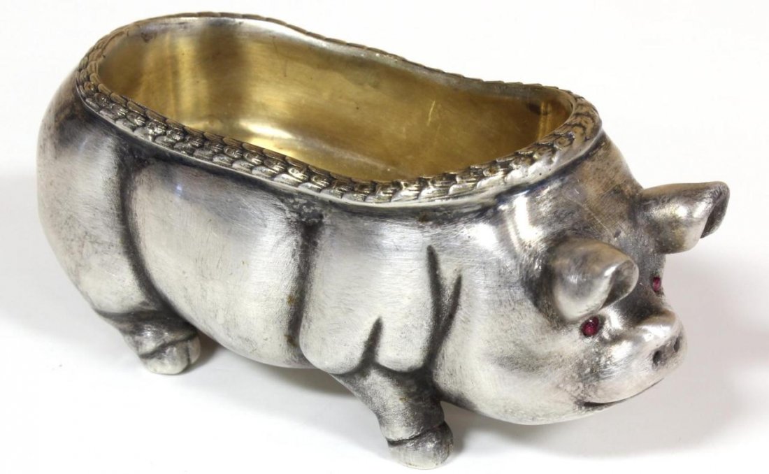 RUSSIAN SILVER PIG FIGURAL SALT CELLAR: Russian silver standing pig figural salt cellar having cabochon cut ruby jewels set to eyes and gold wash to bowl. Bowl has stylized laurel leaf border design. Holds town marks and 84 silver purity ma