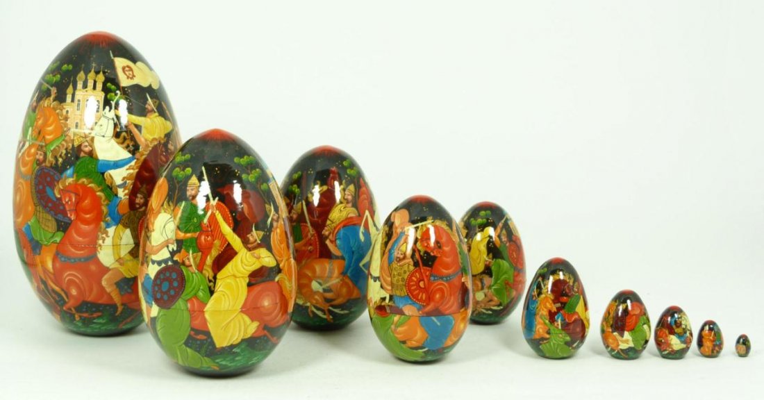 ARTIST SIGNED 10 LAYER RUSSIAN LACQUER NESTING EGG: Large modern Russian lacquered nesting egg comprised of 10 layers of intricately painted scenes. All are depicting a Russian battle scene. The largest egg is signed to the base in Cyrillic. Largest eg