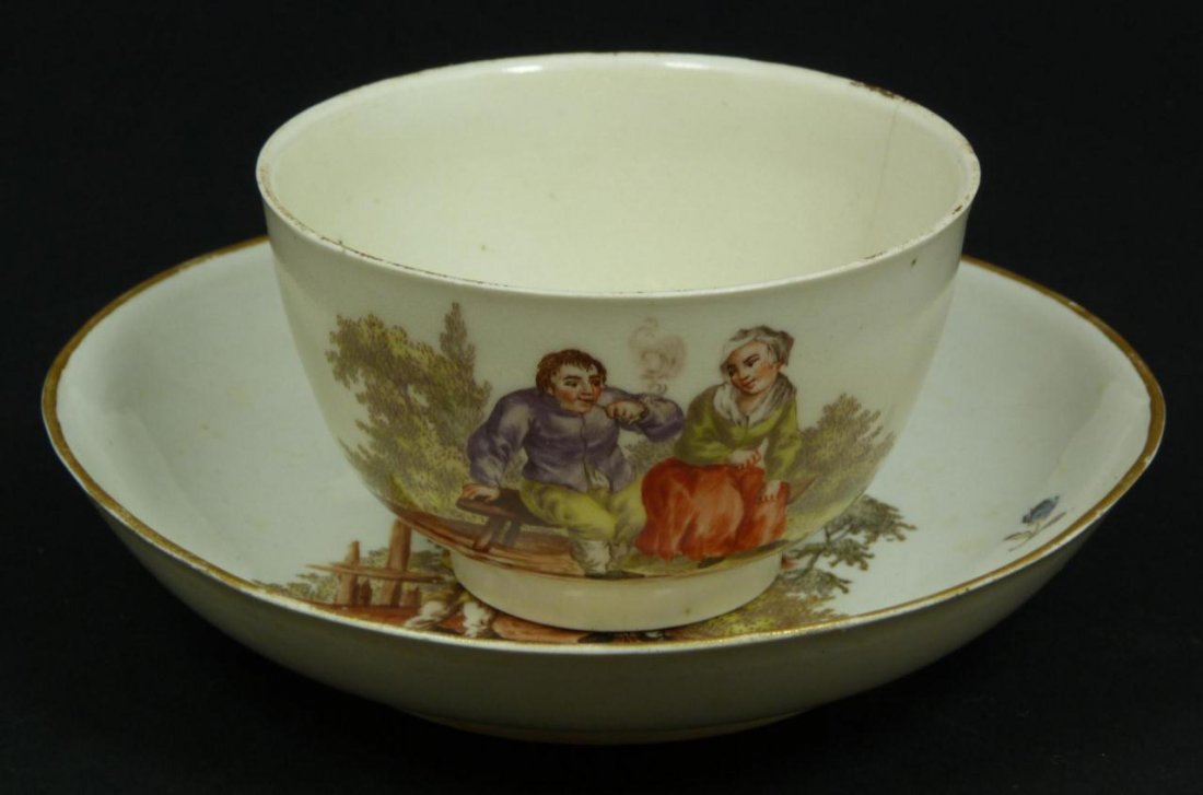 18th C LUDWIGSBURG PORCELAIN CUP & SAUCER: An antique Ludwigsburger hand painted porcelain cup and saucer set depicting couples and flowers. Holds blue crown mark over CC to bottom of each piece. Made during the period of Duke Carl Eugen (1744
