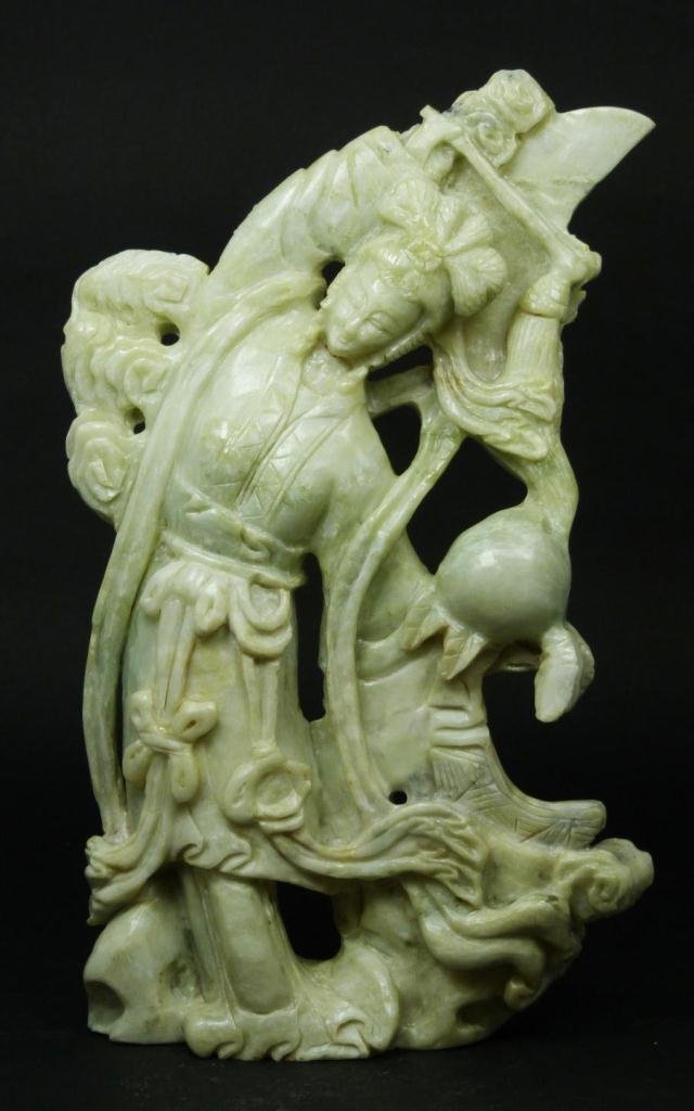 CHINESE GREEN SOAPSTONE QUAN YIN FIGURE: A Chinese hand carved soapstone figure depicting a standing Guan yin holding a baton and tassel. Measures 12 1/4" height (31.1cm). Total weight of 2587 grams.