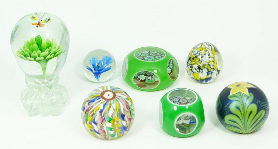 A LOT OF 7 ASSORTED FLORAL PAPERWEIGHTS: A lot of 7 floral paperweights including an Orient & Flume iridescent paperweight made in 1978. Largest measures 6" height (15.2cm).