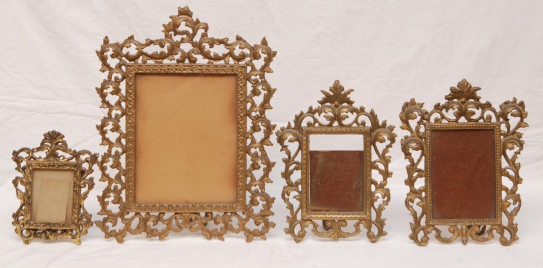 A LOT OF 4 ANTIQUE BRONZE PICTURE FRAMES: A lot of 4 antique scrolled bronze picture frames. Each having glass screen. 19th century. Largest measures 17" height x 13" width (43.1cm x 33cm).