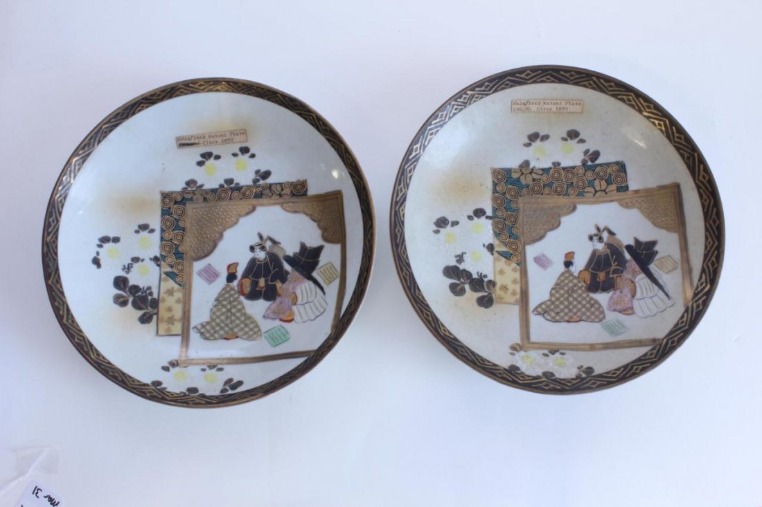 Pr. ANTIQUE JAPANESE KUTANI PORCELAIN PLATES: Pair of antique Japanese Kutani hand painted porcelain plates each depicting seated man and women with flowers. Holds red calligraphy mark to bottom. Circa 1870. Each measures 1 3/4" height x 9 1/8" d