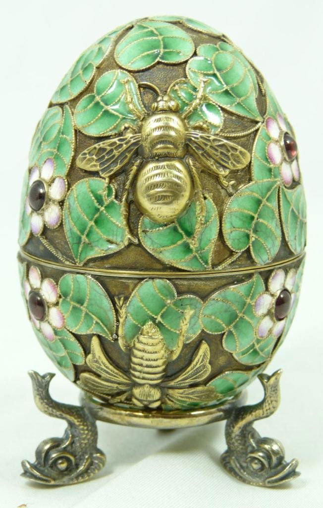 RUSSIAN SILVER ENAMELED FLIES EGG w STAND: Russian silver enameled egg box having floral design throughout with raised gold wash flies and bees. Has 8 cabochon cut rubies set throughout. Gold wash interior. Holds Cyrillic Pavel Akimov Ovchinni