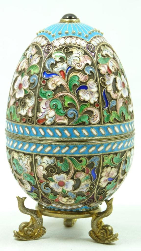RUSSIAN SILVER ENAMELED FLORAL EGG: Finely crafted Russian silver egg with multicolor enameled design throughout. Has Cabochon ruby to top and bottom. Holds town marks, 88 silver purity marks and Feodor Ruckert Cyrillic work master mark