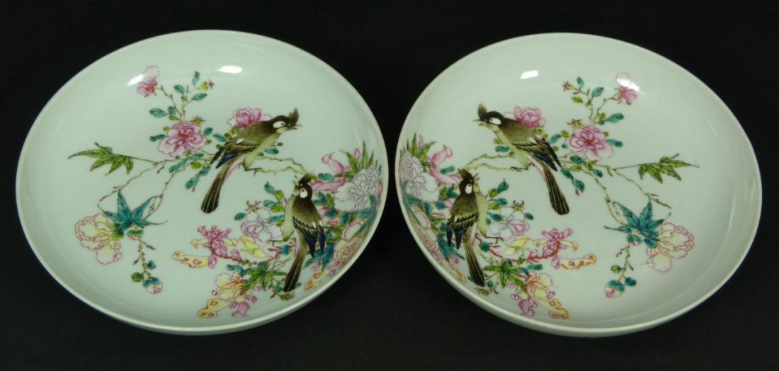 A PAIR OF 18th CENTURY CHINESE FAMILLE ROSE BOWLS: A pair of antique Qing dynasty period Chinese hand painted enameled Famille Rose bowls depicting birds with flowers to interior. Exterior holds rust bats. Each holds blue six character archaic Qianlon