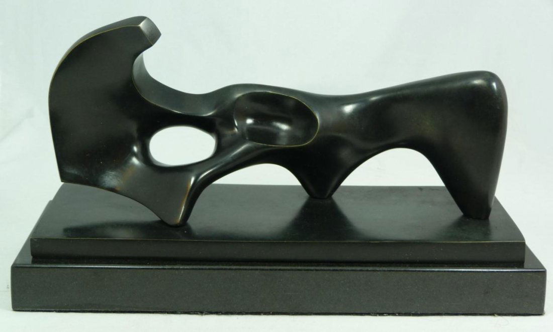 BRONZE ABSTRACT SCULPTURE AFTER HENRY MOORE: A bronze sculpture of abstract shape after Henry Moore (BRITISH, 1898-1986). Singed 'Moore' and numbered 3/9 to bronze base. Mounted to black marble base. Measures 5 1/2" height x 12 5/8" length x 4 1