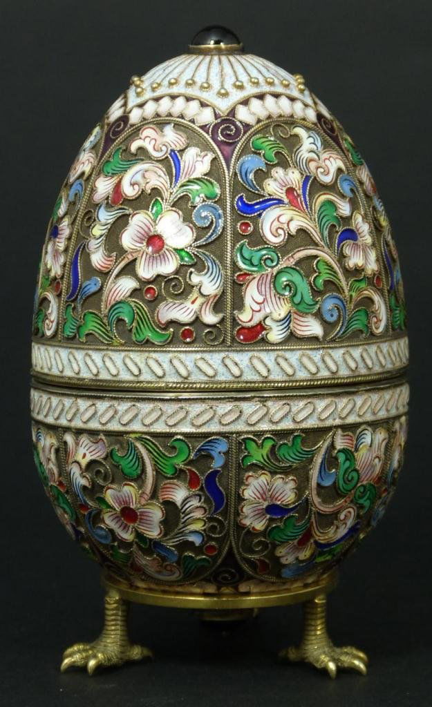 RUSSIAN SILVER ENAMELED EGG RUCKERT: Finely crafted Russian silver egg with multicolor enameled design throughout. Has Cabochon ruby stone to top and bottom. Holds Imperial Warrant marks, town marks, 84 silver purity marks and MC workmas