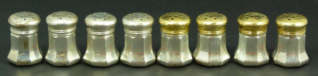 8 CARTIER PARIS STERLING SALT & PEPPER SHAKERS: A lot of 8 Cartier Paris, France sterling silver salt and pepper shakers. 4 have gold tone covers. Each marked 'Catier STERLING' to bottom. Includes original fitted presentation box. Each measures app