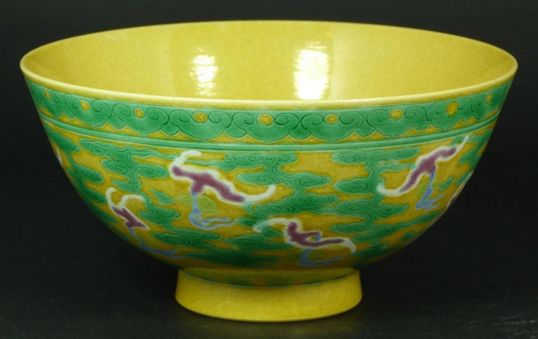 18th C CHINESE YELLOW GROUND & GREEN BATS BOWL: An antique Chinese hand painted yellow ground footed bowl having green clouds with red bats. Green lingzhi border design to rim. Holds six character black calligraphy Yongzheng (1723-1735) period mark