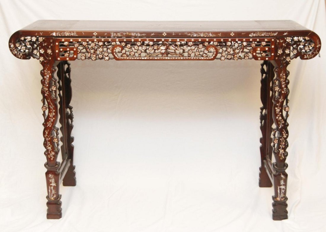 A CHINESE MOTHER OF PEARL INLAY ALTAR TABLE: A Chinese wooden mother of pearl inlaid altar table. Intricate detail throughout depictig flowers and birds. Sides having reticulated design. 19th/20th century. Measures 42" height x 65" length x 17" 