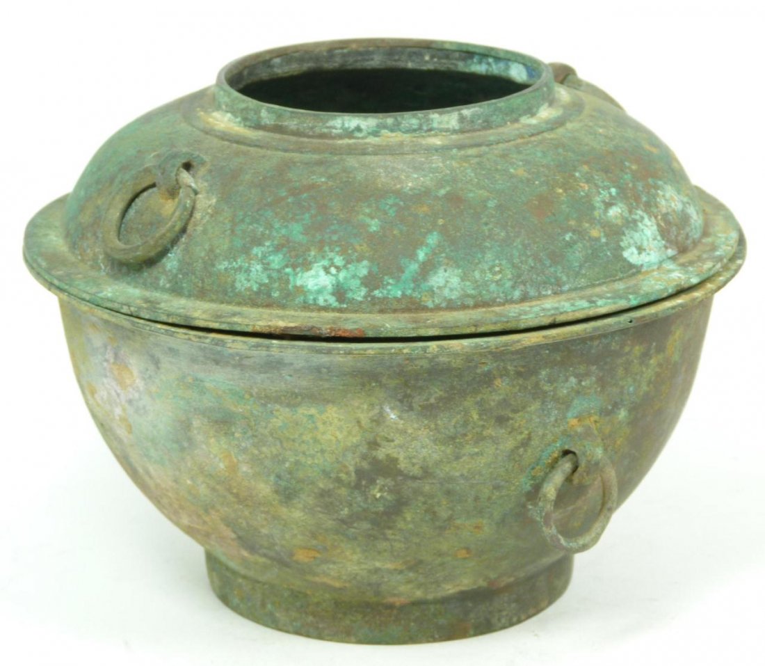 CHINESE HAN DYNASTY 2pc BRONZE XIAN STEAMER: An antique Chinese Han Dynasty two piece bronze Xian steamer. Has two ring handles to each part. Measures 6 1/8" height x 6 1/4" diameter (15.5cm x 15.8cm). Total weight of 1204 grams. Provenance: Fro