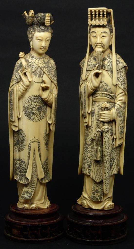 Pr CHINESE IVORY EMPEROR & EMPRESS FIGURES: Pair of Chinese ivory hand carved figures depicting Emperor & Empress. The emperor holding ceremonial sword with hand to beard. The Empress is depicted holding ruyi scepter with pheonix head dress. Ea