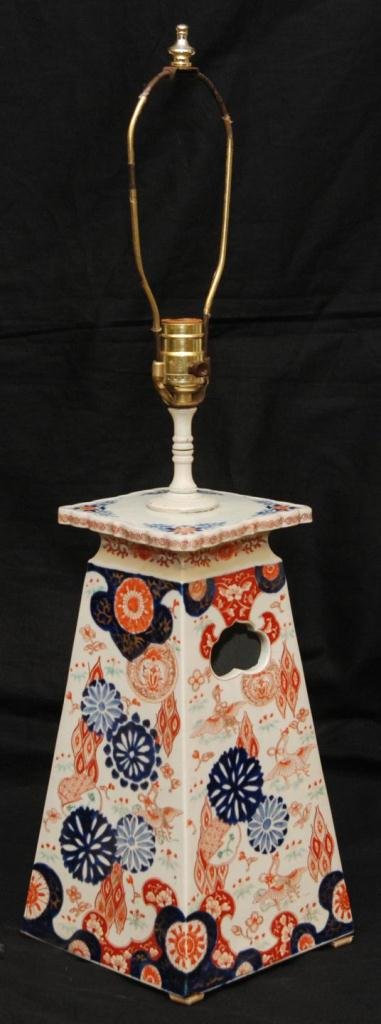 JAPANESE IMARI TAPERED PORCELAIN LAMP: An antique Japanese Imari tapered porcelain floral pedestal lamp. Has reticulated lingzhi handle design to two sides. 19th/20th century. Pedestal measures 13 7/8" height x 7 1/2" width x 7 1/2" depth 